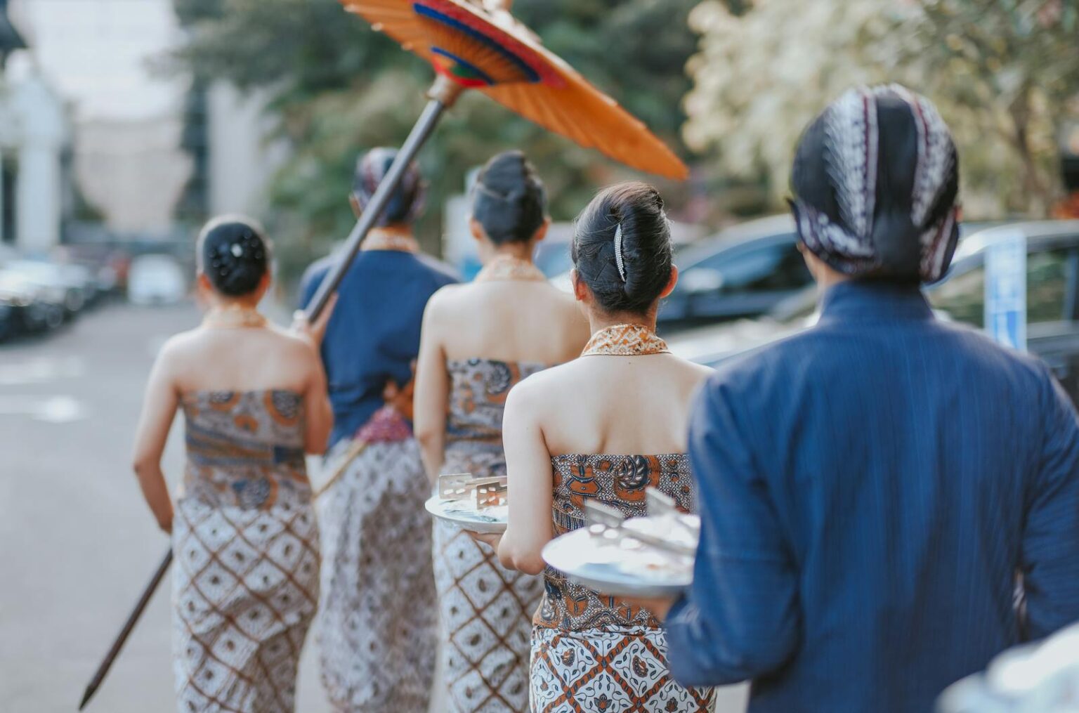 A cultural parade in Yogyakarta showcasing traditional Indonesian attire and ceremonial elements.
