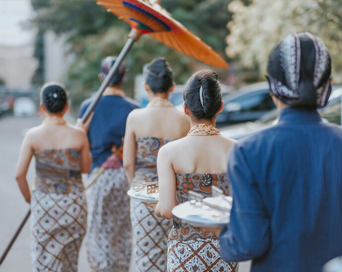 A cultural parade in Yogyakarta showcasing traditional Indonesian attire and ceremonial elements.