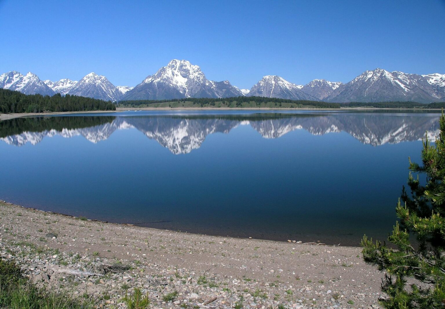 body of water under blue sky