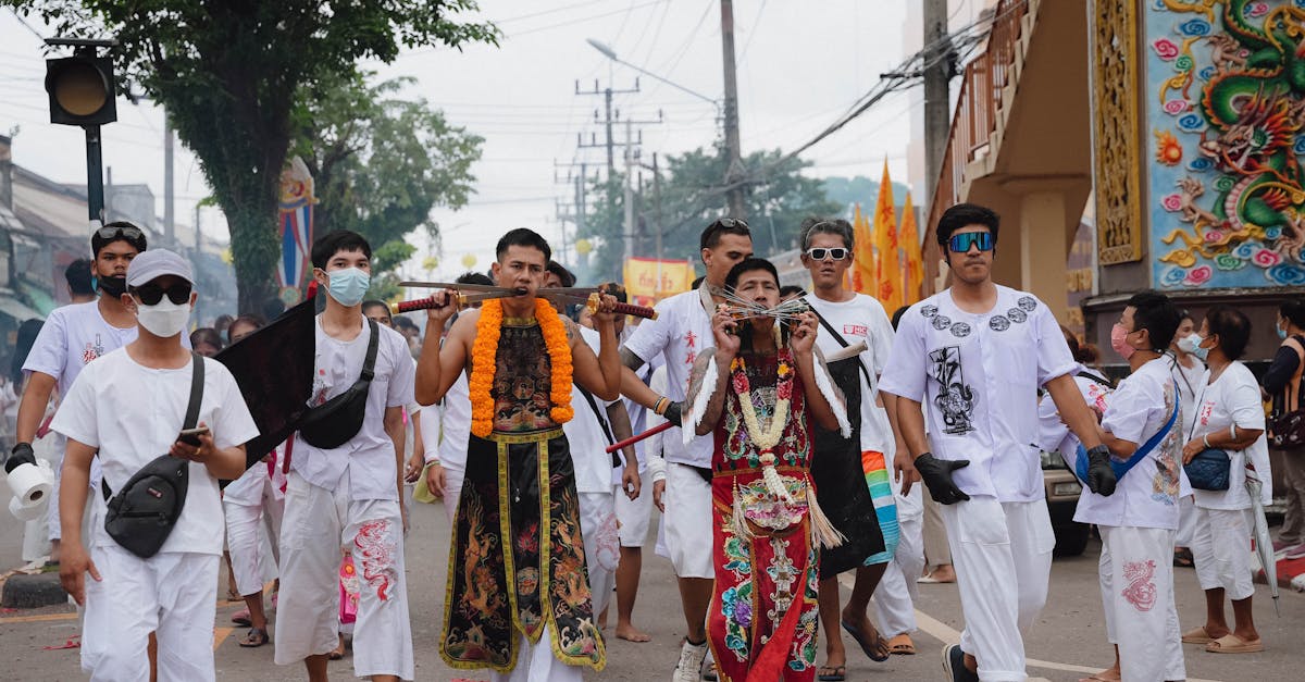 Participants in a vibrant Thai vegetarian festival parade through the streets of Phuket.